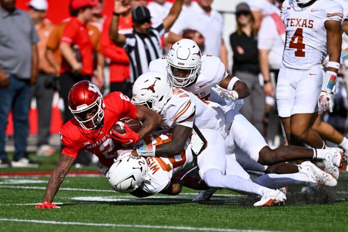 The Texas defense swarms a Houston ball carrier